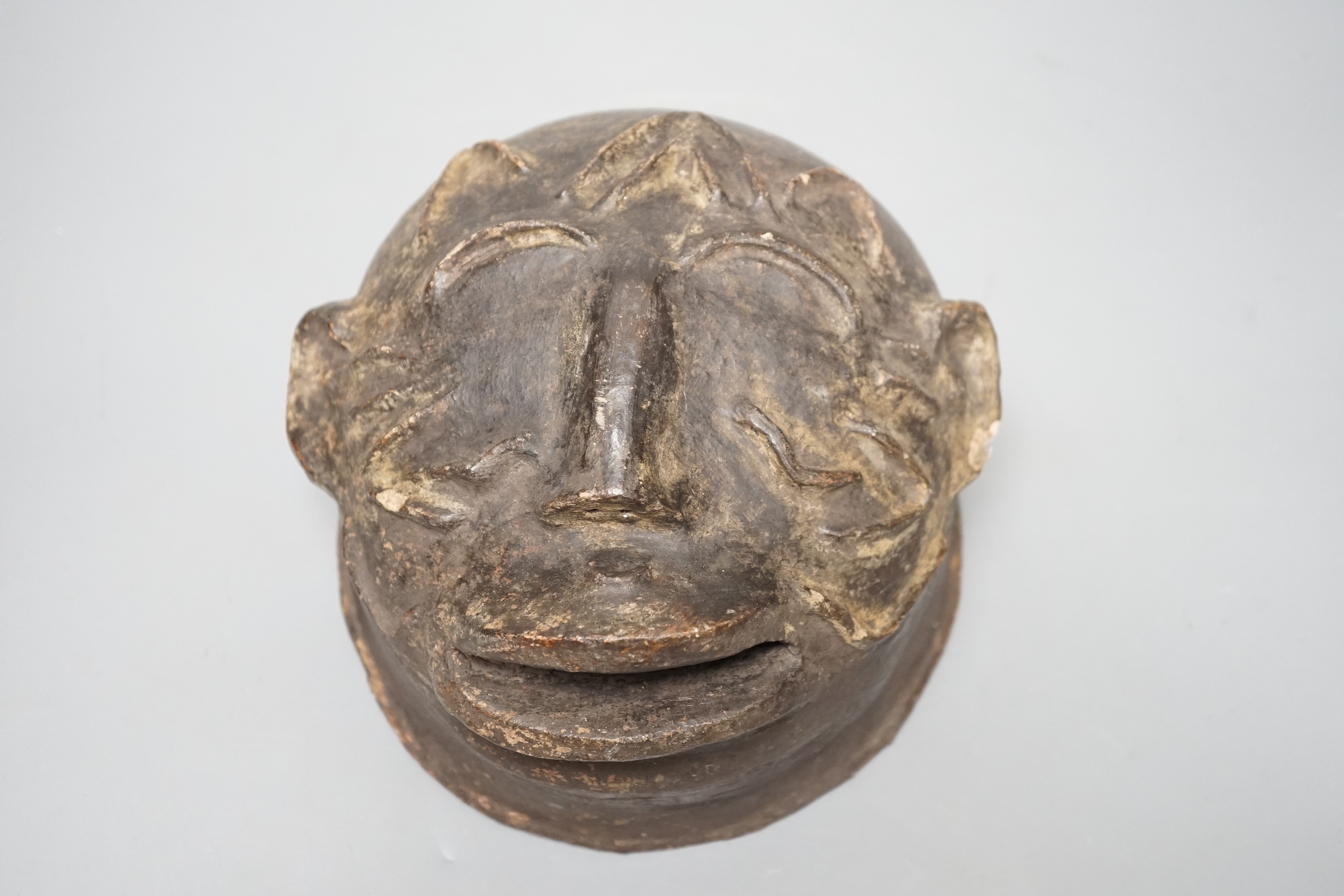 A terracotta Makonde helmet mask (Tanzanian) 21cm diameter